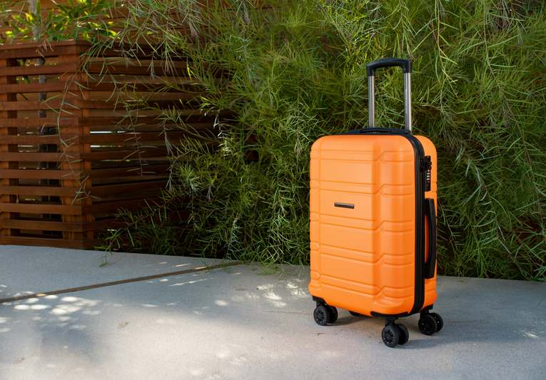 Diverse group of travel influencers posing with premium luggage at an airport